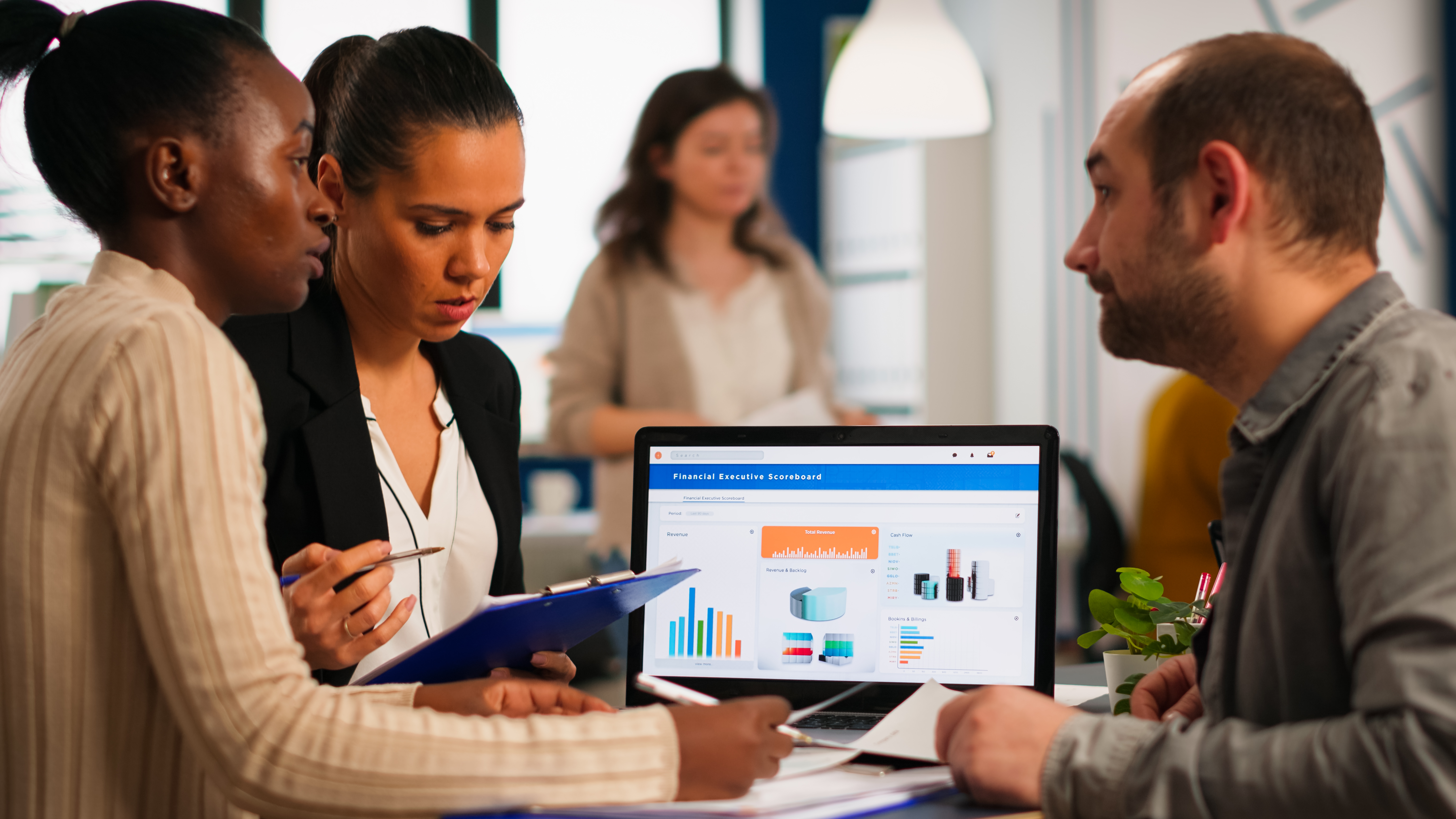 Marketers reviewing social media ads performance on a laptop