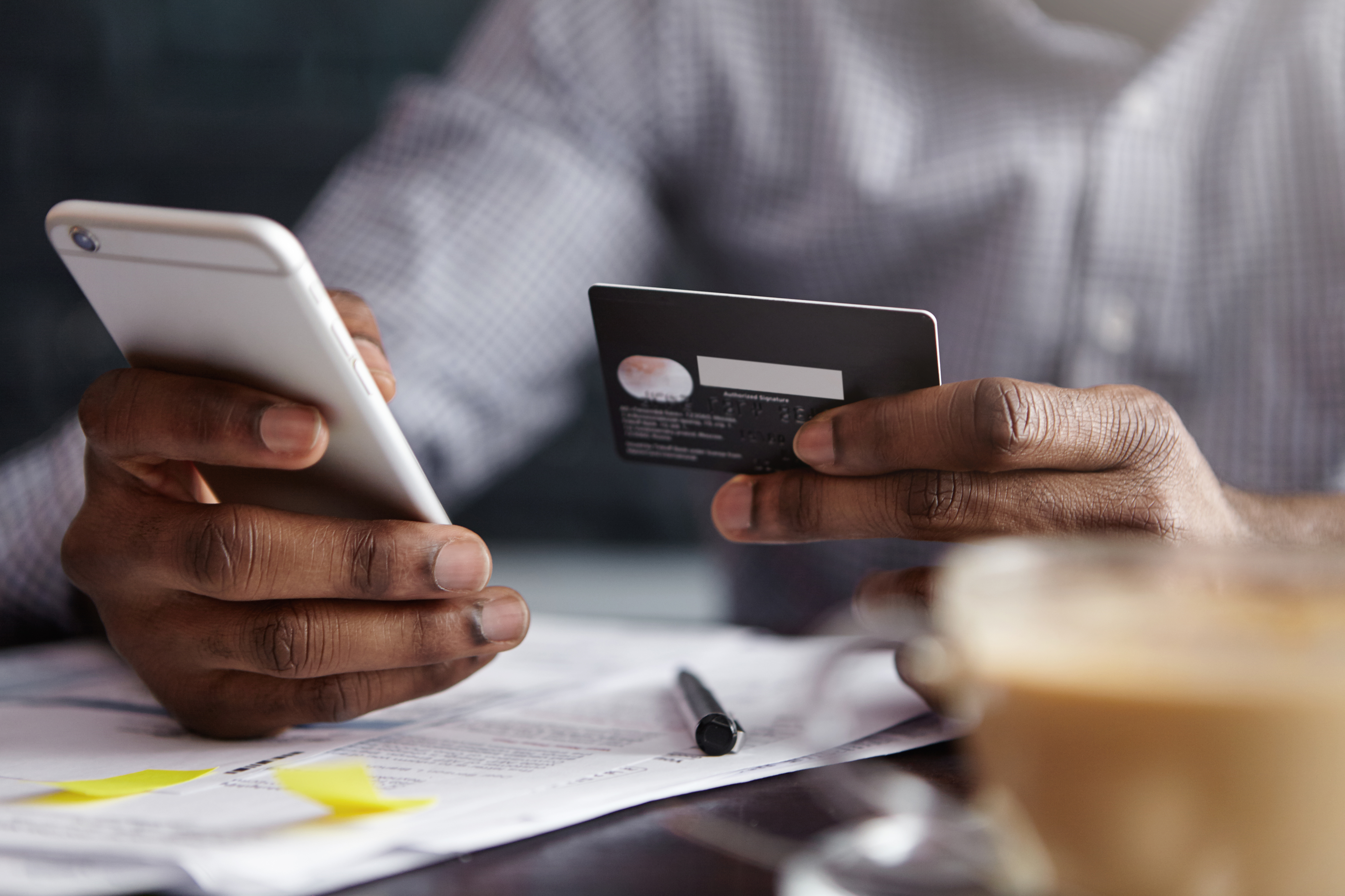 Man sorting out recurring payment with a card Man sorting out recurring payment with a card