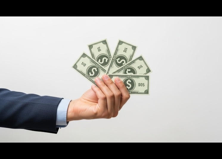 hand holding money for better money habits