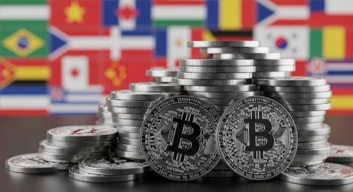 Stacks of digital coins with international flags in the background